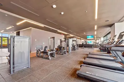 a gym with rows of treadmills and machines at Fly Hight - Studio W Free Parking in Miami