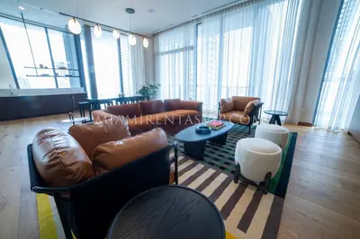 a living room with leather couches and a table at Crosby Miami World Center in Miami