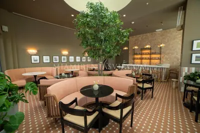 a restaurant with tables and chairs and a bar at Crosby Miami World Center in Miami