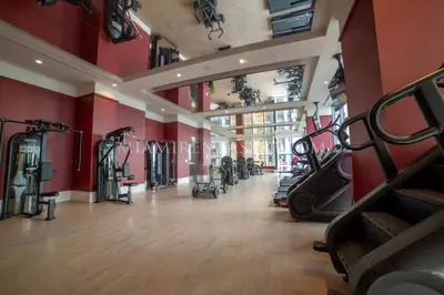 a gym with treadmills and elliptical machines at Crosby Miami World Center in Miami
