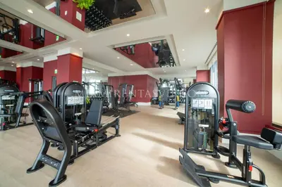 a gym with treadmills and ellipticals in a room at Crosby Miami World Center in Miami