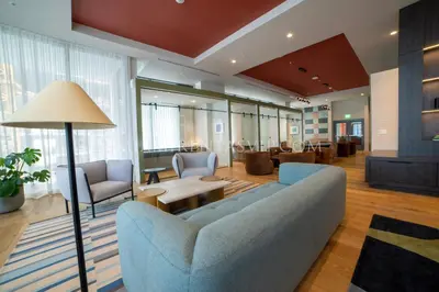 a living room with a blue couch and chairs at Crosby Miami World Center in Miami