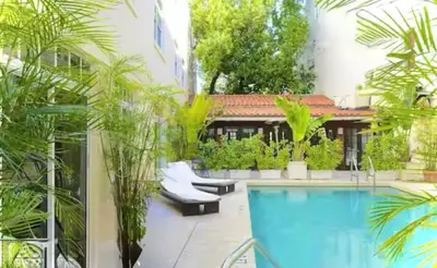 a courtyard with a swimming pool and plants at Chic & Cozy 1BR in Miami Best South Beach Location in Miami Beach