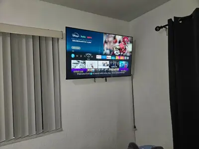 a flat screen tv hanging on a wall at Miami Mini Escape 5 minutes from the airport in Miami