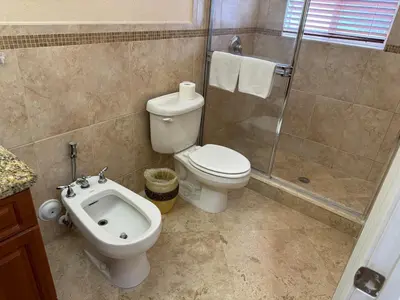 a bathroom with a toilet and a shower and a sink at Miami Mansion for Groups Sleeps 12 in Kendale Lakes