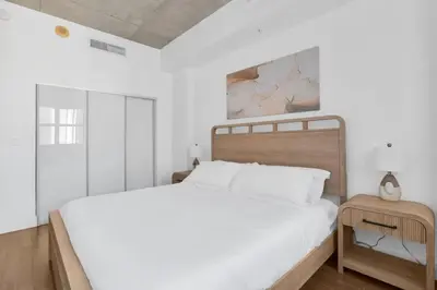 a white bedroom with a bed and a table at Modern Luxury Studio for Two in Downtown in Miami