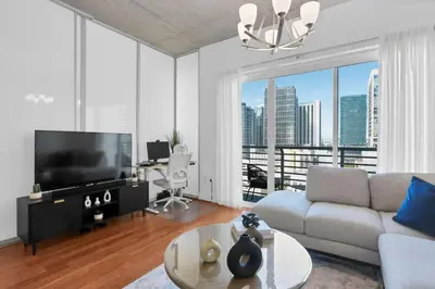 a living room with a couch and a large window at Modern Luxury Studio for Two in Downtown in Miami