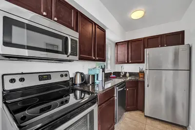 a kitchen with a stainless steel refrigerator and a microwave at Desoto 2 bedrooms first floor in Hollywood