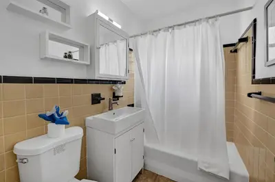 a bathroom with a white toilet and a shower at Desoto 2 bedrooms first floor in Hollywood