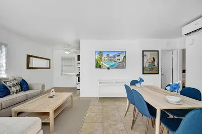 a living room with a table and blue chairs at Desoto 2 bedrooms first floor in Hollywood