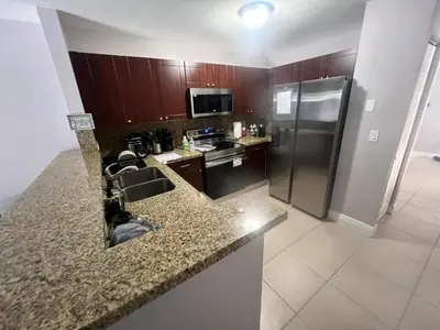 a kitchen with a sink and a refrigerator at Vacation QJR in Cutler Bay