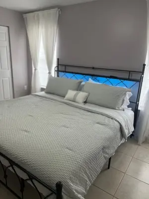 a bedroom with a large bed with white pillows at Vacation QJR in Cutler Bay