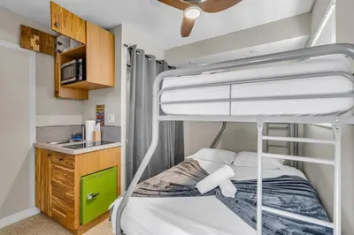 a bunk bed in a small room with a kitchen at Compact Miami Suite in Miami