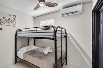 a bedroom with two bunk beds and a ceiling fan at Compact Havana Suites - With Self Check-in in Miami