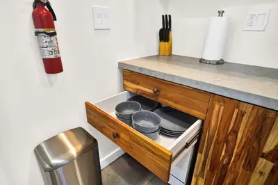 a kitchen with a counter with dishes in a drawer at Compact Havana Suites - With Self Check-in in Miami