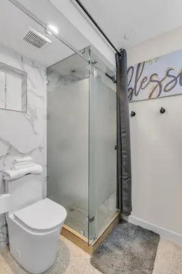 a bathroom with a glass shower and a toilet at Compact Havana Suites - With Self Check-in in Miami