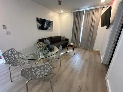 a living room with a glass table and chairs at Prime Brickell Suites - One Free Parking With Self Check-in in Miami