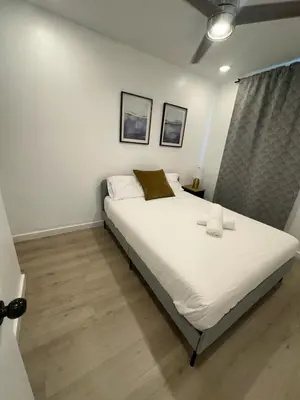 a bedroom with a white bed with two candles on it at Prime Brickell Suites - One Free Parking With Self Check-in in Miami