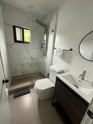 a bathroom with a shower and a toilet and a sink at Prime Brickell Suites - One Free Parking With Self Check-in in Miami