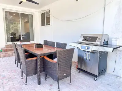 a patio with a table and chairs and a grill at Family Pool Retreat 3 BR House for more than 8 Guests in Hollywood