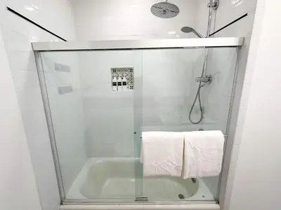 a bathroom with a shower and a tub with a glass door at Family Pool Retreat 3 BR House for more than 8 Guests in Hollywood