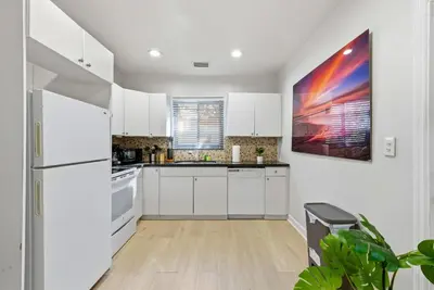 a kitchen with white cabinets and a refrigerator at Prime Location Miami House W Free Parking in Miami