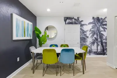 a dining room with a white table and chairs at Prime Location Miami House W Free Parking in Miami