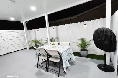 a white table and chairs on a patio at Private & Quiet Retreat Near Hard Rock Stadium and Guitar Hotel in Pembroke Pines