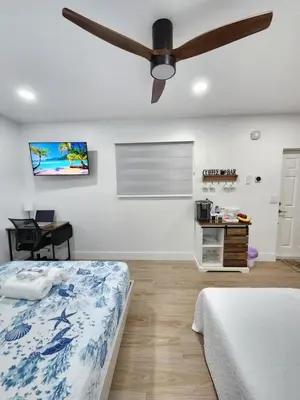 a bedroom with two beds and a ceiling fan at Private & Quiet Retreat Near Hard Rock Stadium and Guitar Hotel in Pembroke Pines