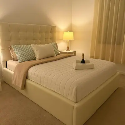 a bedroom with a large bed with a lamp on it at NEW House, Near Beaches, and MIA, Sleeps 8! in Westview