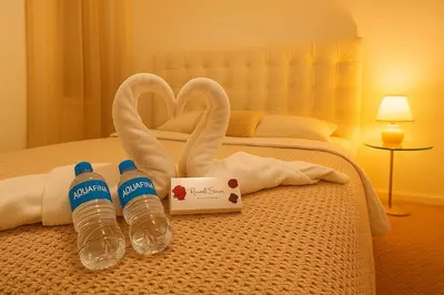 two bottles of water on a bed with towels at NEW House, Near Beaches, and MIA, Sleeps 8! in Westview