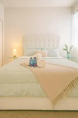 a bedroom with a white bed with towels on it at NEW House, Near Beaches, and MIA, Sleeps 8! in Westview