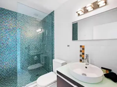 a bathroom with a sink and a glass shower at Villa Zenora in Miami