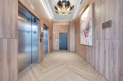 a hallway with wooden walls and a chandelier at Brickell Border 3BR by Untitled Stay in Miami
