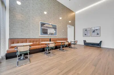 a waiting room with tables and chairs and a couch at Brickell Border 3BR by Untitled Stay in Miami