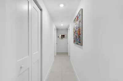 a hallway with white walls and a white door at Brickell Border 3BR by Untitled Stay in Miami