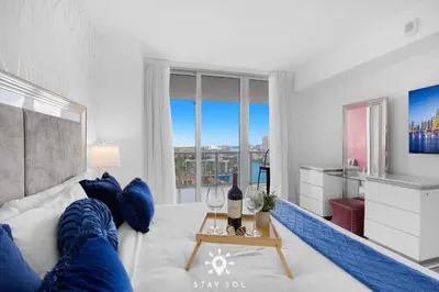 a living room with a white couch and a large window at Spacious 2BR apt - Amazing Balcony View in Hallandale Beach