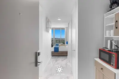 a kitchen with a door leading to a bedroom at Spacious 2BR apt - Amazing Balcony View in Hallandale Beach