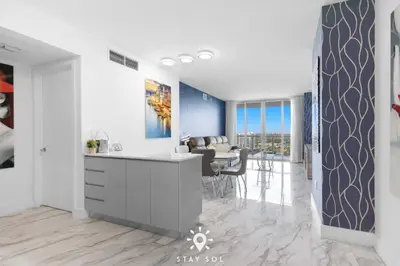 a kitchen and living room with a table and chairs at One Bedroom - Amazing Balcony in Hallandale Beach