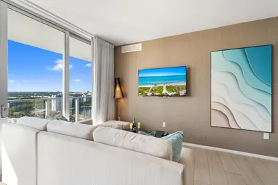 a living room with a white couch and a large window at Spectacular 3br and 2ba in Hyde Beach House in Hollywood