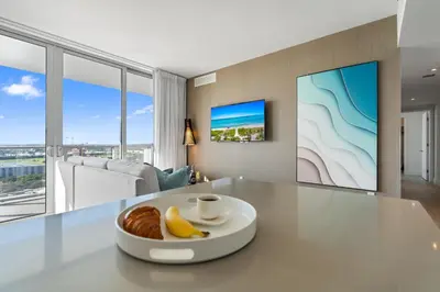 a table with a plate of bread and bananas on it at Spectacular 3br and 2ba in Hyde Beach House in Hollywood