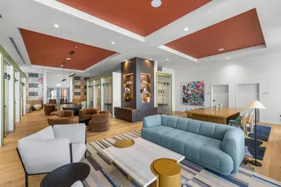 a living room with a blue couch and chairs at Modern Studio w Skyline Views by Bayfront Park in Miami