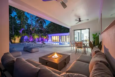 a living room with a couch and a fire pit at Two Neighboring Villas in The Heart of Miami in Miami