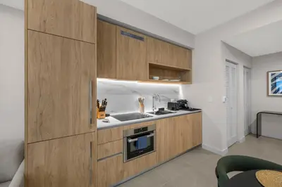 a kitchen with wooden cabinets and a sink at Downtown lifestyle - Luxury condo & Rooftop Pool in Miami