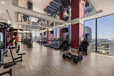 a gym with treadmills and exercise equipment in a building at Spectacular Cityviews - Steps from Bayfront Park in Miami