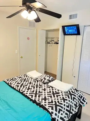 a bedroom with a bed and a ceiling fan at Queen with Private Dedicated Spa Bath in Miami