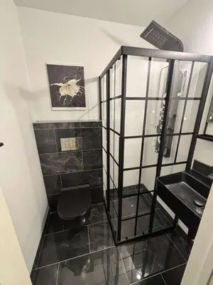a bathroom with a black toilet and a shelf at Queen with Private Dedicated Spa Bath in Miami
