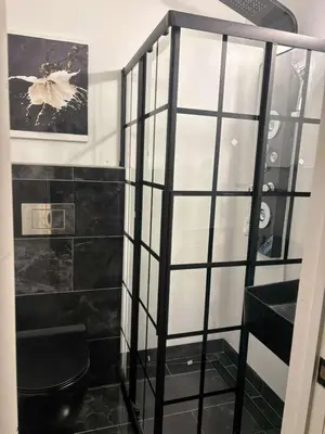 a bathroom with a black toilet and a shelf at Queen with Private Dedicated Spa Bath in Miami