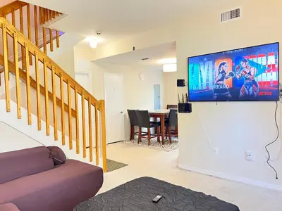 a living room with a flat screen tv on a wall at Queen with Private Dedicated Spa Bath in Miami