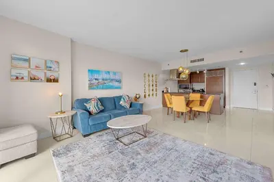 a living room with a blue couch and a table at Luxury Waterfront W Hotel Condo Brickell Skyline Views in Miami